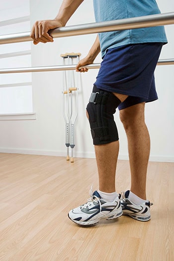 Man Walking with Railing in Physical Therapy