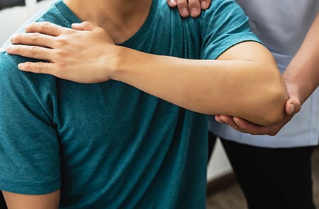 Physical Therapist Stretching a Patient's Arms